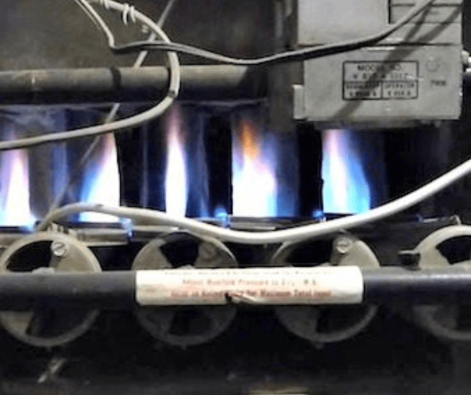Inside view of a furnace with blue burner flames