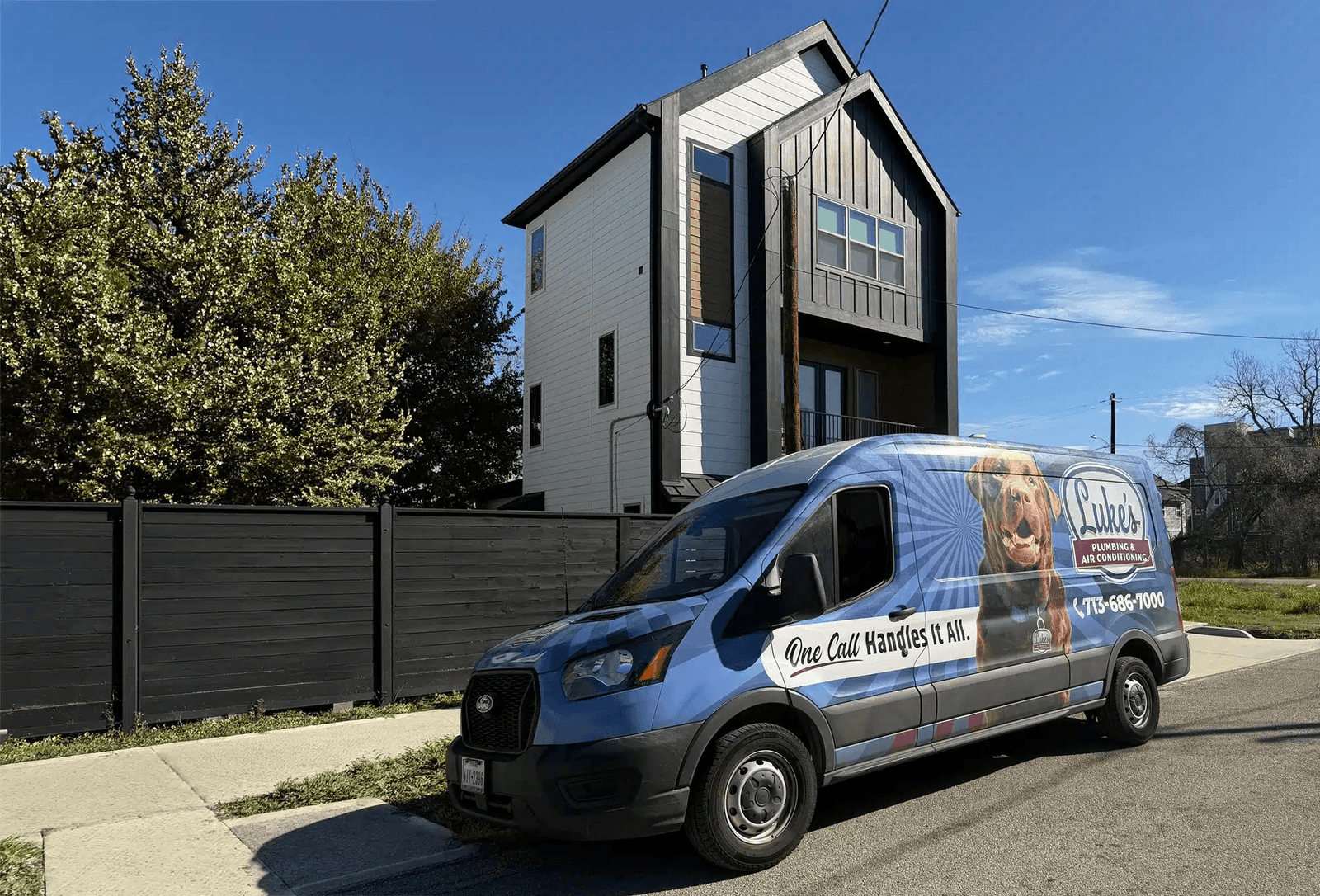 A Luke's Plumbing & Air Conditioning branded service van parked outside a Houston Heights home